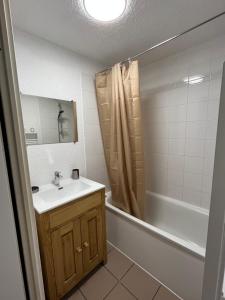 a bathroom with a sink and a tub and a shower at L'Épicéa - Praz in Praz-sur-Arly +9 photos