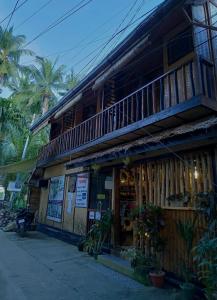 a store front of a building with a balcony at Hidden of Cailan Extension Transient House in El Nido