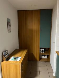 a room with a wooden desk and a cabinet at L'Épicéa - Praz in Praz-sur-Arly