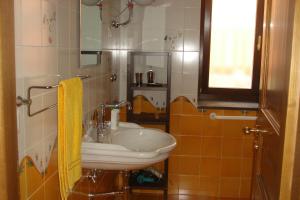 baño con lavabo blanco y ventana en Agriturismo Ai Monaci, en Montano Antilia