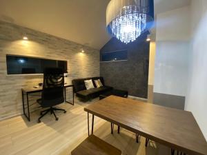 a living room with a dining table and a chandelier at Shibuya Anon #A204 in Tokyo
