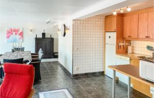cocina y comedor con silla roja y mesa en Gorgeous Apartment In Sdra Vi With Kitchen, en Södra Vi