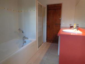 een badkamer met een bad, een wastafel en een bad bij Castalan in Gaas