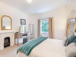 a bedroom with a bed with a fireplace and a mirror at North Lodge-uk45599 in Southwell