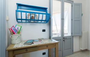 Zimmer mit einem Holztisch und einem blauen Regal in der Unterkunft La Casa Di Marina 2 in Marittima
