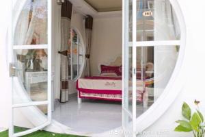 a bedroom with a bed and a large mirror at Da Lat LUCINA Boutique Hotel in Da Lat