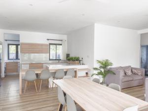a kitchen and living room with a table and chairs at Résidence Coastal View - Privilege Appartement in the heart of Grand-Baie in Grand Baie