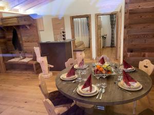 a dining room table with fruits and wine glasses at Alpenchalet Waldruhe in Scheffach