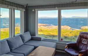 a living room with a couch and a view of the ocean at 2 Bedroom Stunning Home In Rennesy in Hanasand