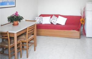 uma sala de estar com um sofá vermelho e uma mesa em Casa Margherita 2 em Codaruina