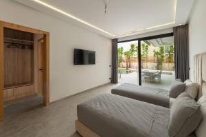 a living room with two beds and a television at Villa Design à Marrakech in Marrakech