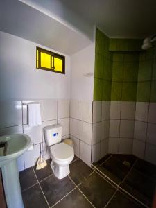 a bathroom with a toilet and a sink at Posada Mia Copacabana in Copacabana