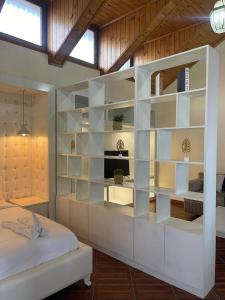 a bedroom with a large white book shelf next to a bed at Social House in Addis Ababa