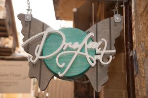 a sign that says open hanging on a building at Dream Art Studios in Chania