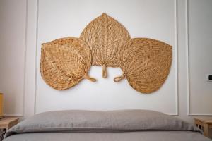 duas asas numa parede acima de uma cama em Casa Blin Dimora a Chiaia em Nápoles