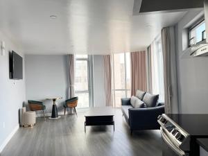 a living room with a couch and a table at Starlight Hotel Near LGA Airport in Queens
