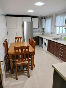 a kitchen with a table and chairs and a refrigerator at Piccadilly Centre Deluxe in Alicante