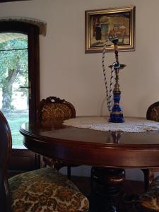 een eettafel met een blauwe vaas erop bij Antica Riserva in Castiglione del Lago