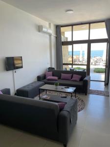 a living room with a couch and a table at Golden Stone Beach 