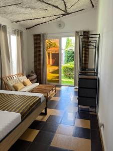 a bedroom with two beds and a checkerboard floor at Keur Ama in Mbour