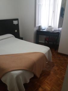 Łóżko lub łóżka w pokoju w obiekcie Hotel Irixo