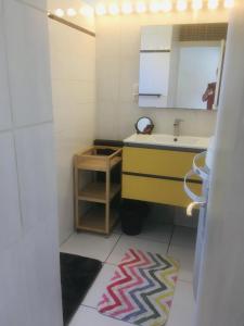 a small bathroom with a sink and a mirror at Gite turon in Saint-Sever