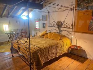 a bedroom with a bed with a metal frame at Mas des eaux claires Arles Camargue in Saint-Gilles