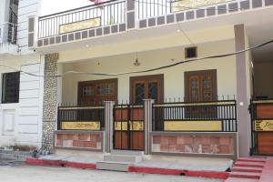 a house with wooden doors and a balcony at Prakriti Homestay in Roorkee