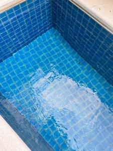a blue swimming pool with water in it at Espana Condo Jomtien Pool access By Aey in Jomtien Beach