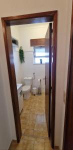 an open door to a bathroom with a toilet at Monte Argil in Montargil