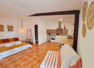 a large room with two beds and a kitchen at Monte Argil in Montargil