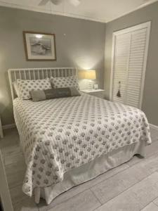 a bedroom with a large bed with a white comforter at Beachfront Condo with Ocean View in Hilton Head Island