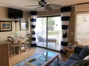 a living room with a couch and a table at Beachfront Condo with Ocean View in Hilton Head Island