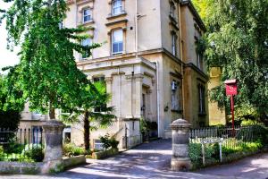 a building with a tree in front of it at Victoria Square Hotel Clifton Village in Bristol