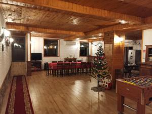 a living room with a christmas tree and a dining room at Хаджи Марковата къща за гости гр.Дряново in Dryanovo