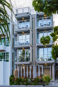 an apartment building with balconies and plants at Vista Beach Retreat in Hulhumale
