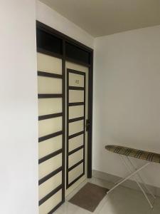 a room with a door and a bench in it at Sunview Residence in Kaashidhoo