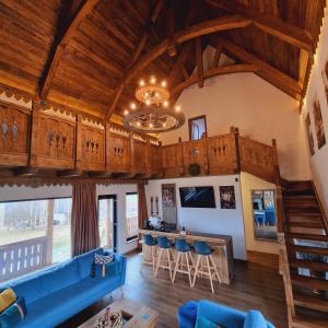 a living room with a blue couch and a table at Plai din Bran in Bran