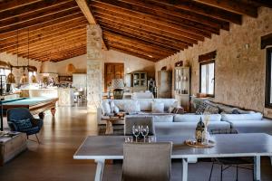 a living room with couches and a pool table at Finca Gomera - Agroturismo Hotel in Cala Pi