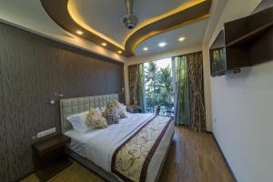 a bedroom with a bed and a large window at Vista Beach Retreat in Hulhumale