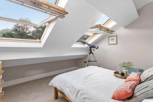 a bedroom with skylights and a bed with a camera at Penthouse 16 At The Beach in Beesands