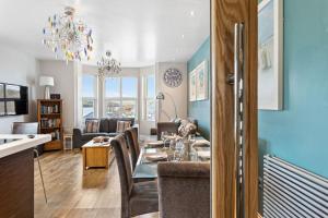 a dining room and living room with a dining table at Penthouse 16 At The Beach in Beesands