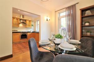 a dining room with a table and chairs and a kitchen at Signature - Lincoln View in Knightswood