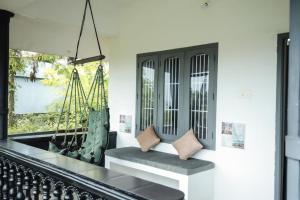 a living room with a bench and a mirror at The First Place Yogaresort, Odayam in Varkala