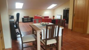 cocina y sala de estar con mesa y sillas en Villa Yolita, en Sepúlveda