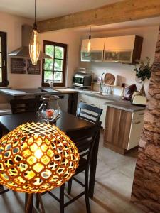 a kitchen with a table and a dining room at Willkommen im Casa Felice, der Wohlfühl Oase mit Balkon, 4 Betten und Homeoffice Platz in Aidlingen