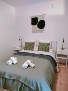 a bedroom with a bed with two towels on it at San Centro IFEMA Wizink Metropolitano Airport Apartments in Madrid