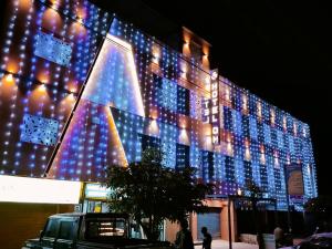 a building with lights on the side of it at Hotel Om in Betūl