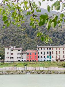 a group of buildings in front of a mountain at Borgo Lungofiume B&B in Valbrenta 