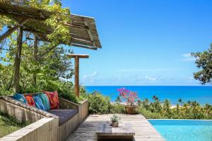 a garden with a bench next to a swimming pool at Casas da Lia in Trancoso